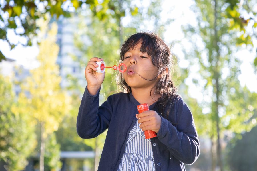 Little girl blowing bubbles_L Local Adoption NSW